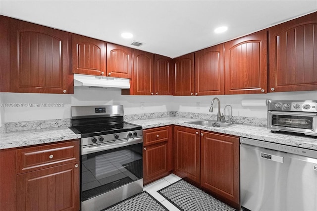 kitchen featuring visible vents, a toaster, under cabinet range hood, a sink, and appliances with stainless steel finishes