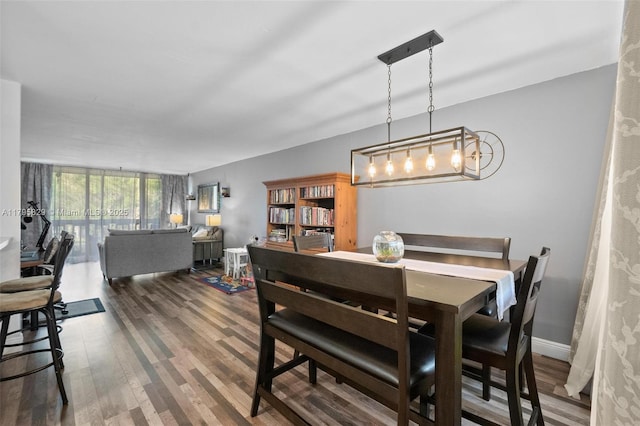 dining space featuring baseboards and wood finished floors