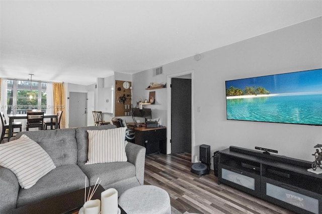 living room featuring visible vents and wood finished floors