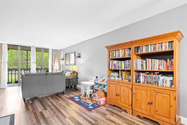 living area with french doors and wood finished floors