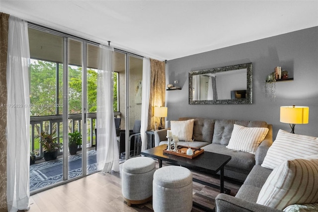 living area with expansive windows and wood finished floors