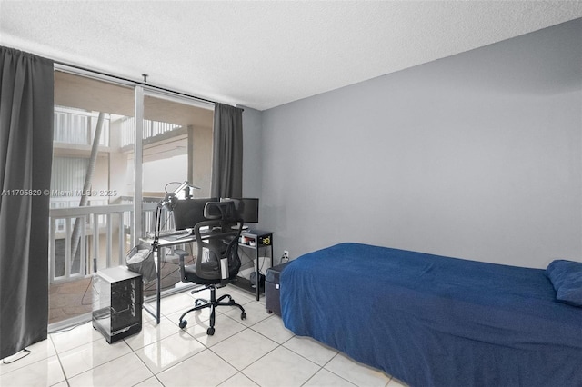 bedroom featuring light tile patterned floors and a textured ceiling