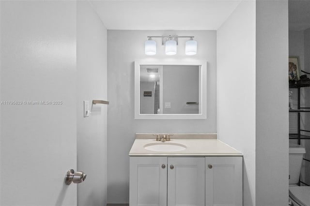 bathroom with vanity and toilet