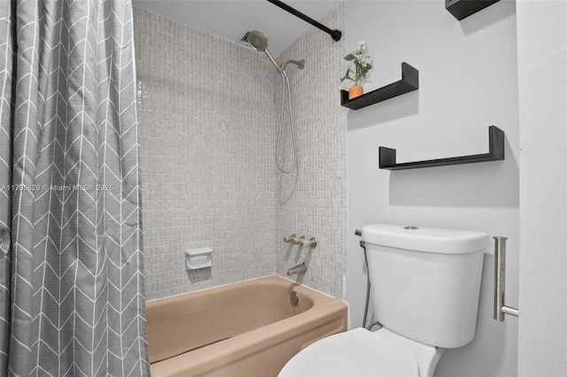 bathroom with shower / bath combo with shower curtain and toilet
