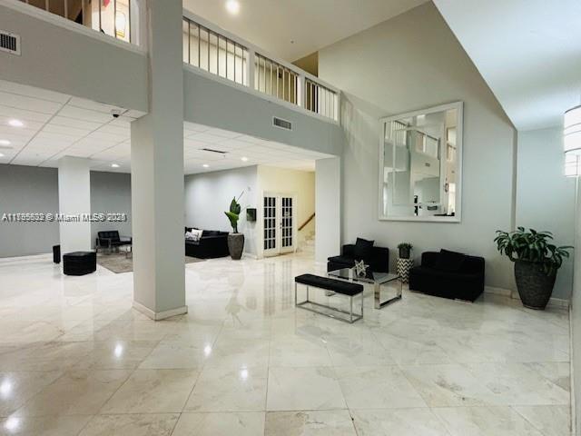 2780 NE 183rd St Unit 810, Aventura, FL 33160 - lobby with stairs, a towering ceiling, and recessed lighting