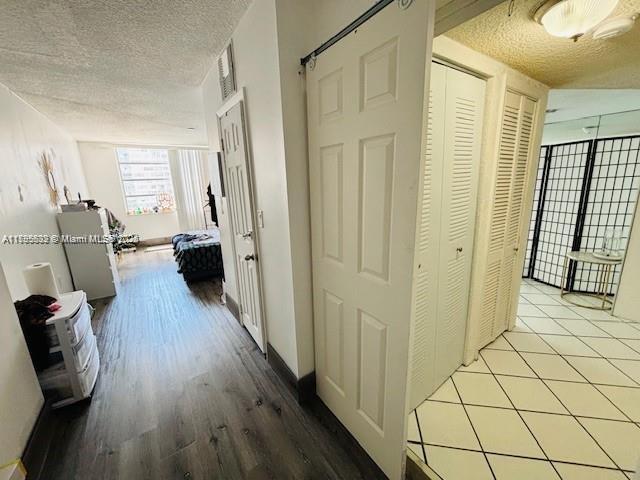 2780 NE 183rd St Unit 810, Aventura, FL 33160 - corridor with a textured ceiling and wood finished floors