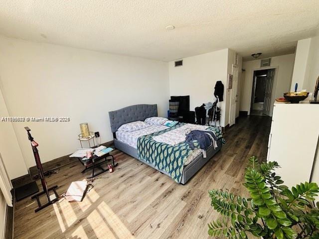 2780 NE 183rd St Unit 810, Aventura, FL 33160 - bedroom with wood finished floors and a textured ceiling