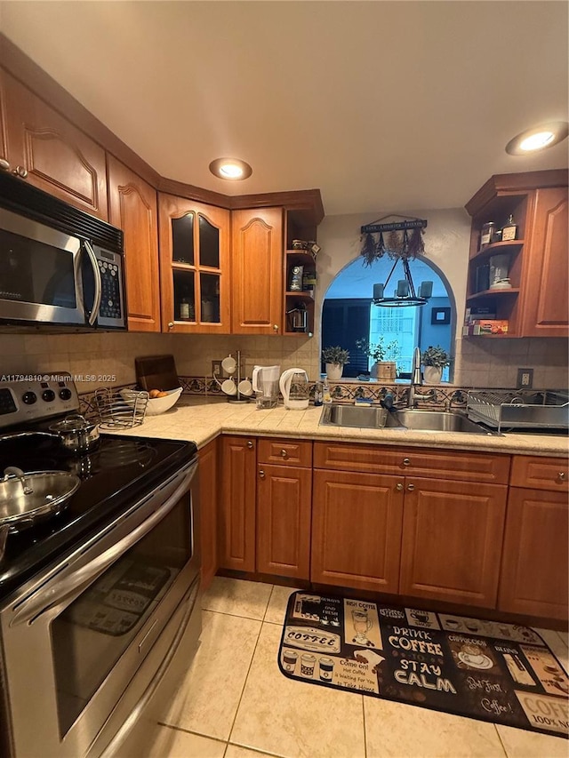 401 Ocean Dr Unit 324, Miami Beach, FL 33139 - kitchen featuring appliances with stainless steel finishes, open shelves, tasteful backsplash, light countertops, and recessed lighting