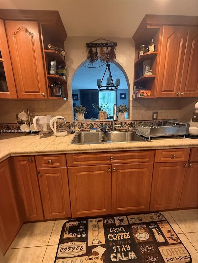 401 Ocean Dr Unit 324, Miami Beach, FL 33139 - kitchen featuring open shelves, light tile patterned flooring, a chandelier, and tasteful backsplash