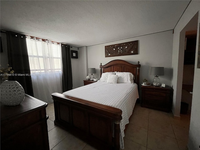 401 Ocean Dr Unit 324, Miami Beach, FL 33139 - bedroom with light tile patterned floors and a textured ceiling