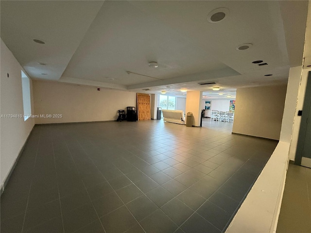 401 Ocean Dr Unit 324, Miami Beach, FL 33139 - unfurnished living room featuring tile patterned flooring and a tray ceiling