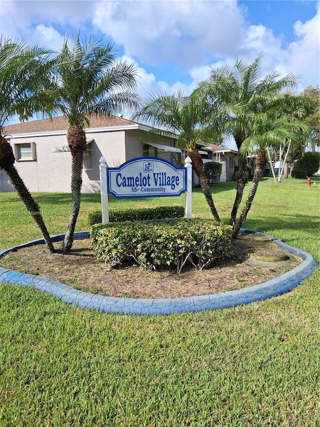 community / neighborhood sign with a yard