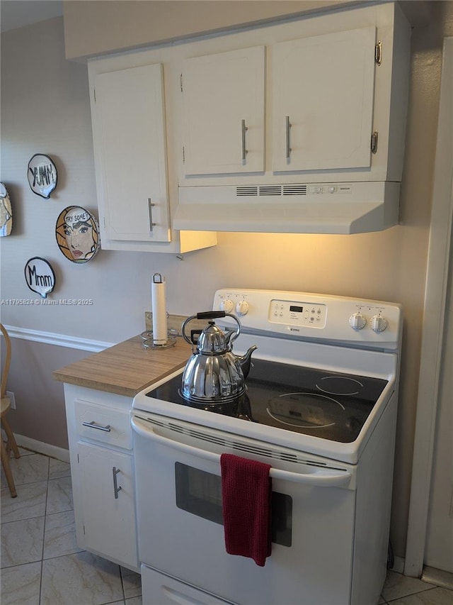 kitchen with white electric range oven, under cabinet range hood, white cabinetry, and marble finish floor