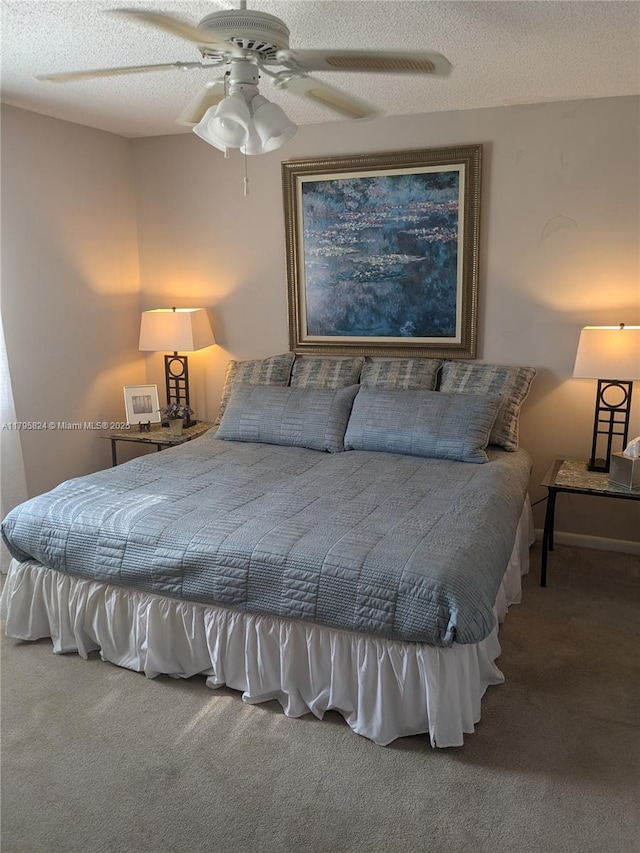 bedroom featuring a textured ceiling, carpet, and ceiling fan