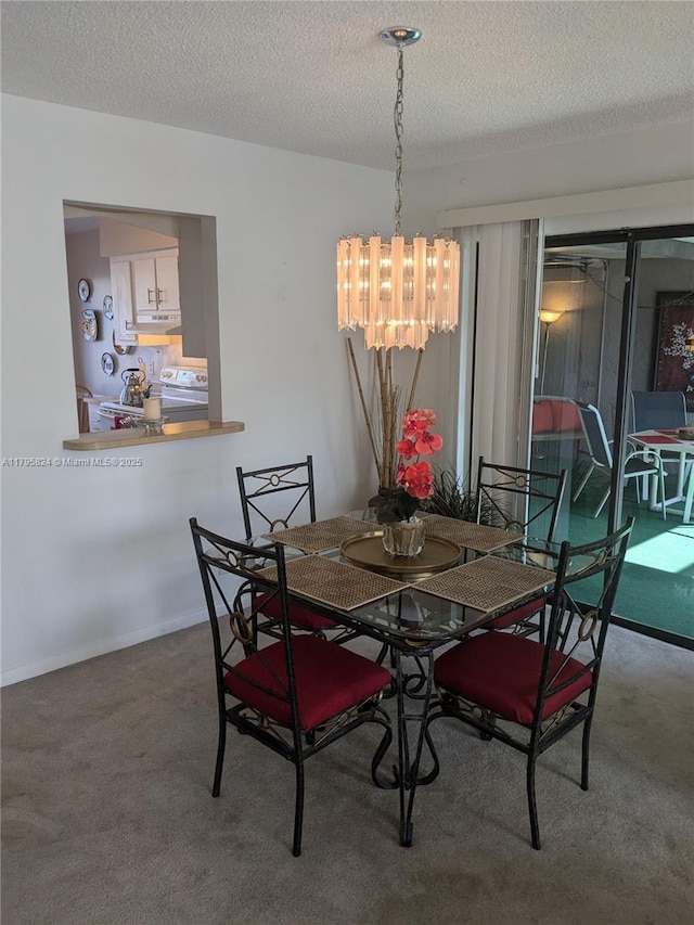 carpeted dining room with a textured ceiling and a chandelier