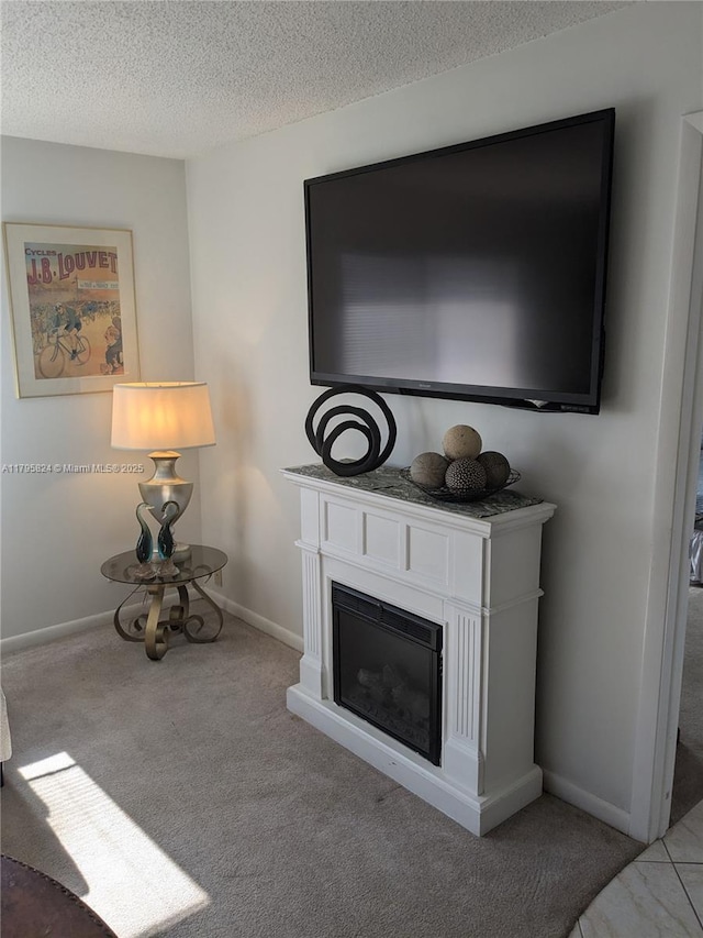 room details featuring carpet flooring, a textured ceiling, a glass covered fireplace, and baseboards