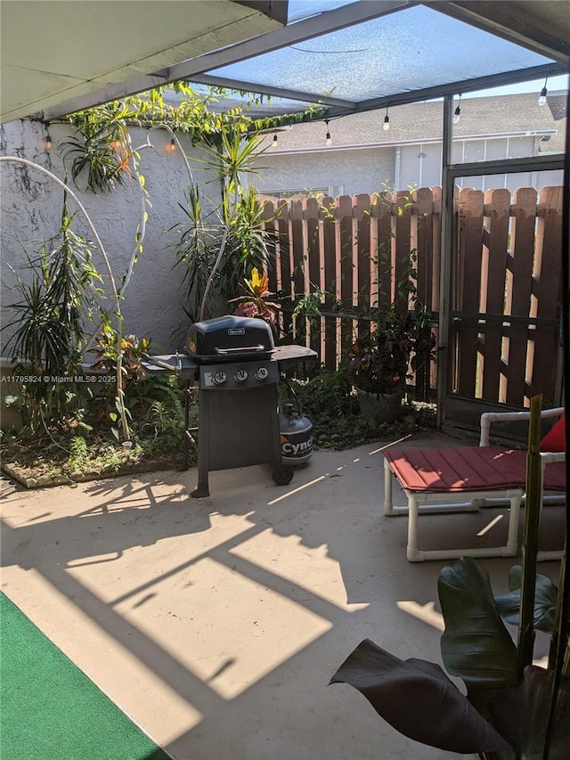 view of patio / terrace with fence and a grill