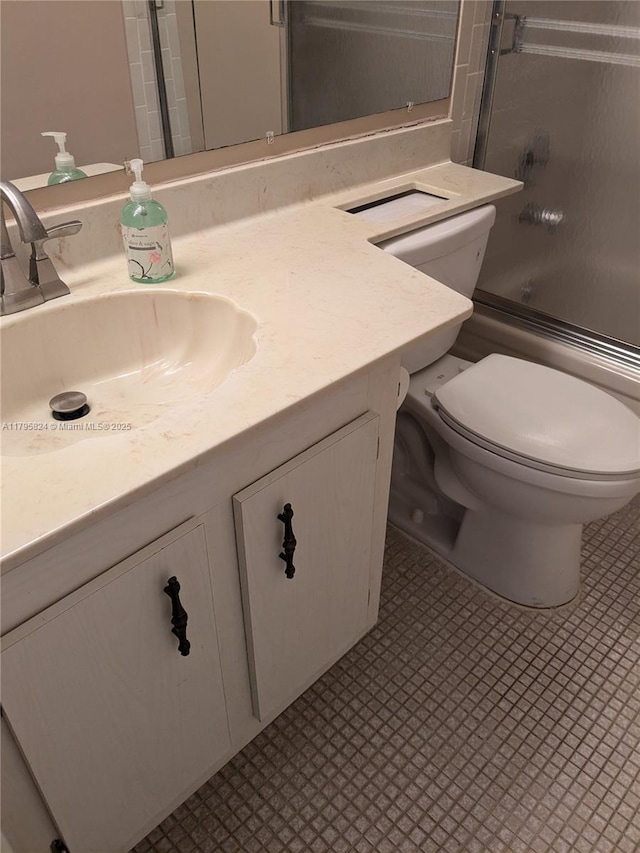 bathroom featuring vanity, toilet, and enclosed tub / shower combo