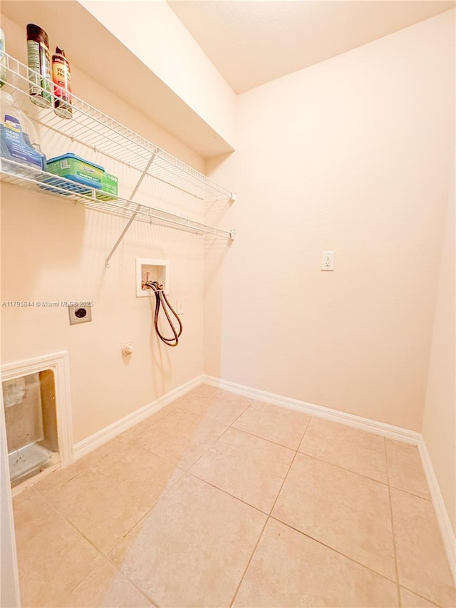 2857 Brewster St, North Port, FL 34288 - laundry area with washer hookup, hookup for an electric dryer, light tile patterned floors, gas dryer hookup, and baseboards