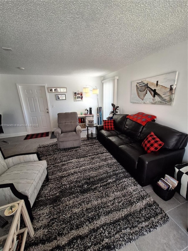 living area with tile patterned floors and a textured ceiling
