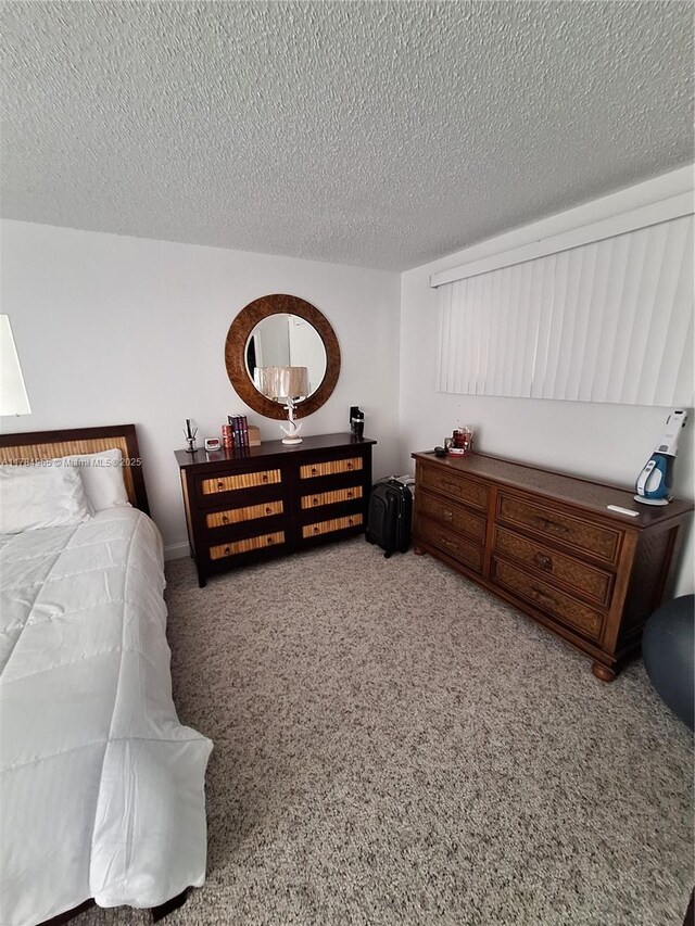 carpeted bedroom with a textured ceiling