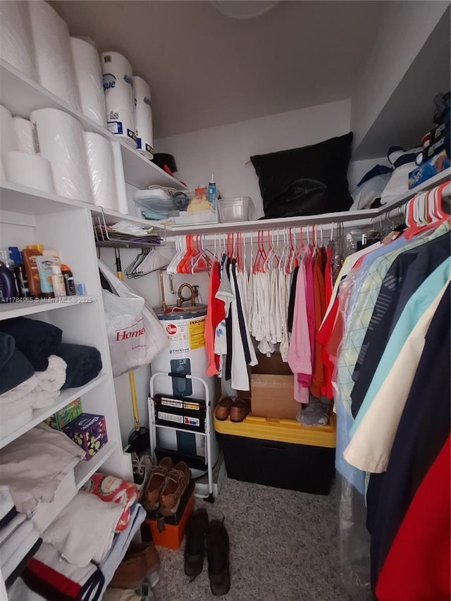 spacious closet with carpet flooring and water heater