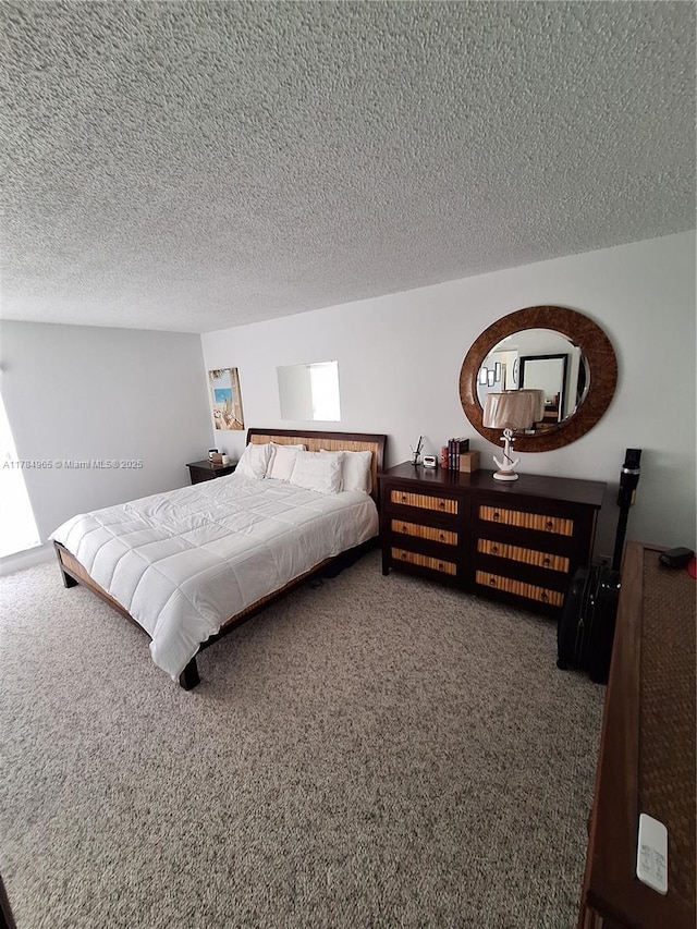 bedroom featuring carpet flooring and a textured ceiling