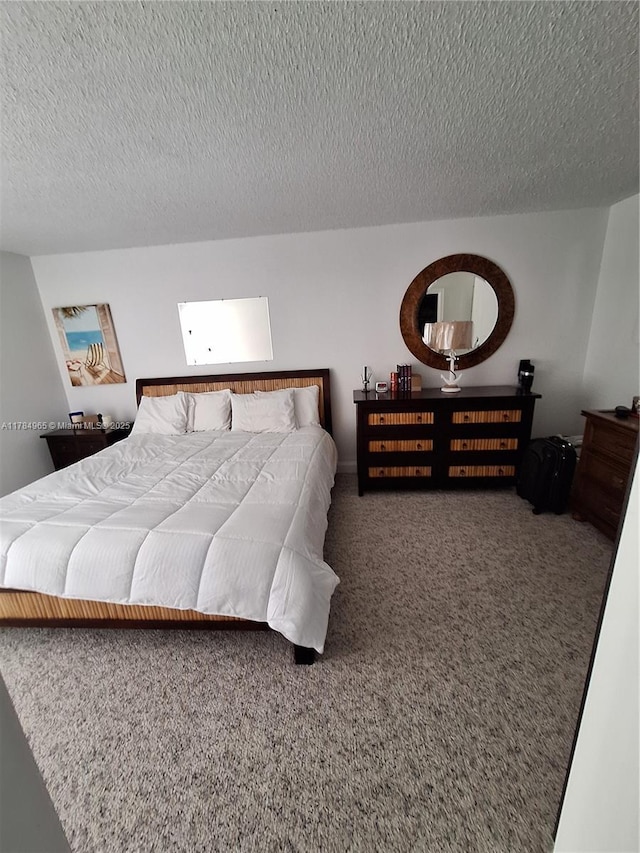 bedroom with carpet floors and a textured ceiling