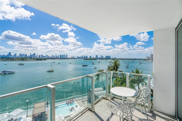 balcony with a water view and a city view