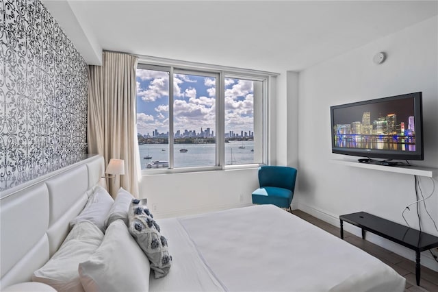 bedroom featuring baseboards and wood finished floors