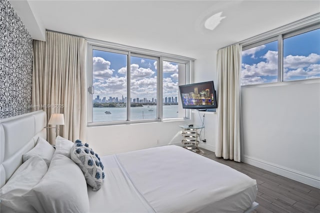 bedroom featuring baseboards and wood finished floors