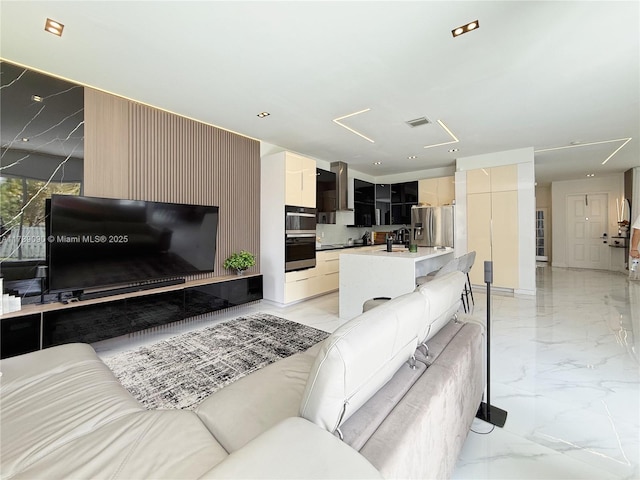 living area featuring visible vents and marble finish floor