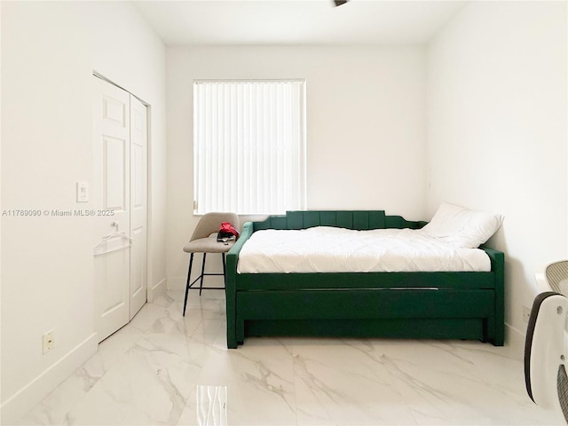 bedroom featuring baseboards and marble finish floor