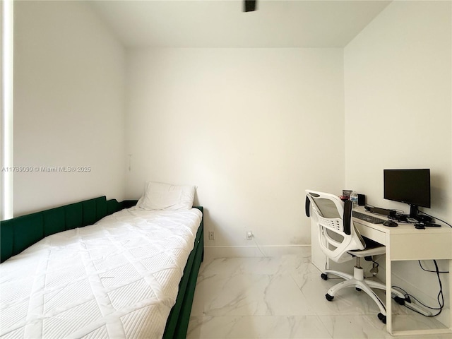 bedroom with baseboards and marble finish floor