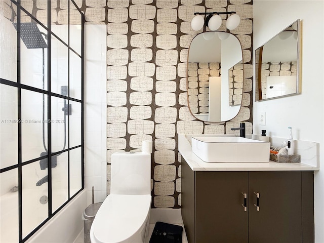 bathroom featuring vanity, bathtub / shower combination, and toilet