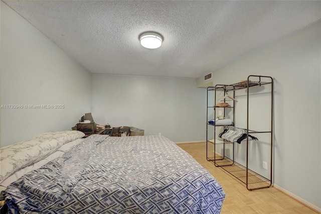 12079 W Regal Ct W, Wellington, FL 33414 - bedroom featuring a textured ceiling and baseboards
