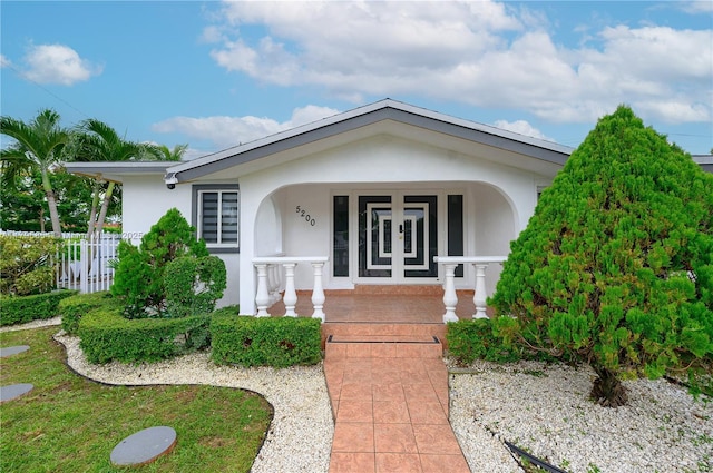 view of front of home with a porch and stucco siding
