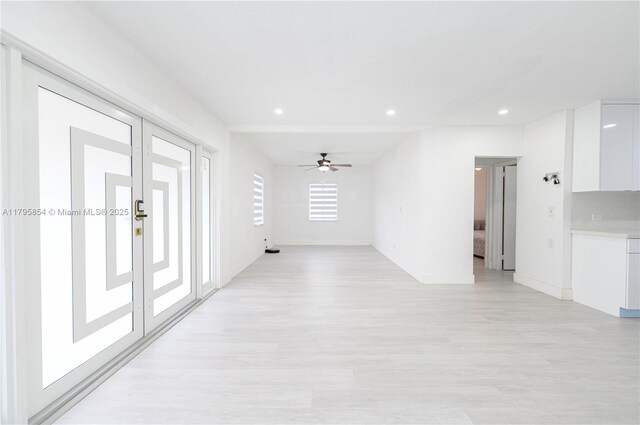 unfurnished living room with recessed lighting, a ceiling fan, light wood-style flooring, and baseboards
