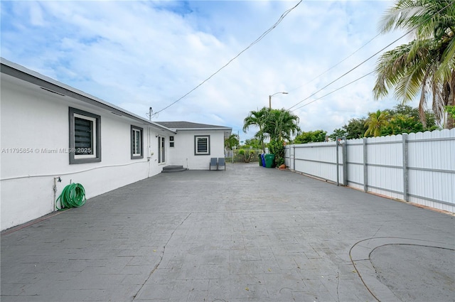 view of patio featuring fence