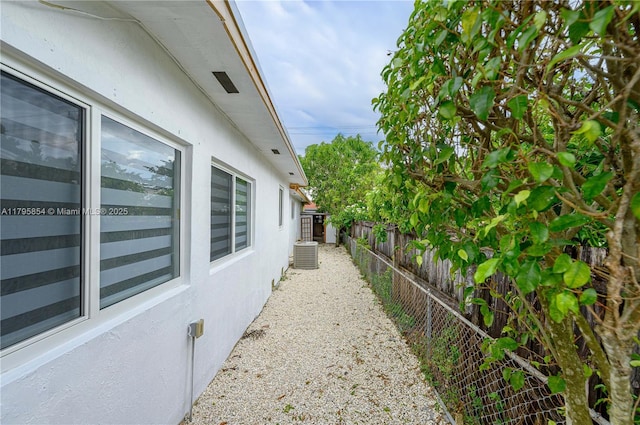 view of property exterior with a fenced backyard and cooling unit