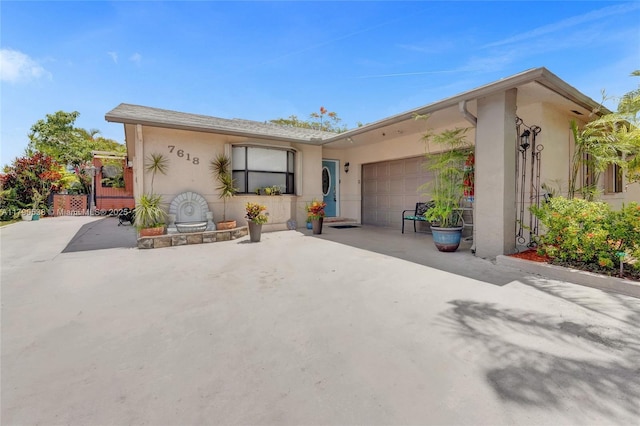 7618 NW 88th Cir, Tamarac, FL 33321 - view of front of home with stucco siding and a garage