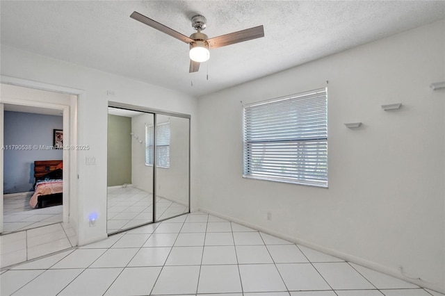 7618 NW 88th Cir, Tamarac, FL 33321 - unfurnished bedroom featuring a closet, a textured ceiling, ceiling fan, and baseboards