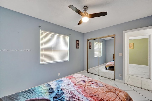 7618 NW 88th Cir, Tamarac, FL 33321 - bedroom with light tile patterned floors, a closet, a ceiling fan, and baseboards