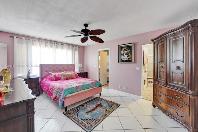 7618 NW 88th Cir, Tamarac, FL 33321 - bedroom featuring baseboards, light tile patterned floors, connected bathroom, and ceiling fan