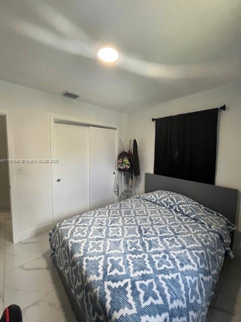 bedroom featuring visible vents and a closet