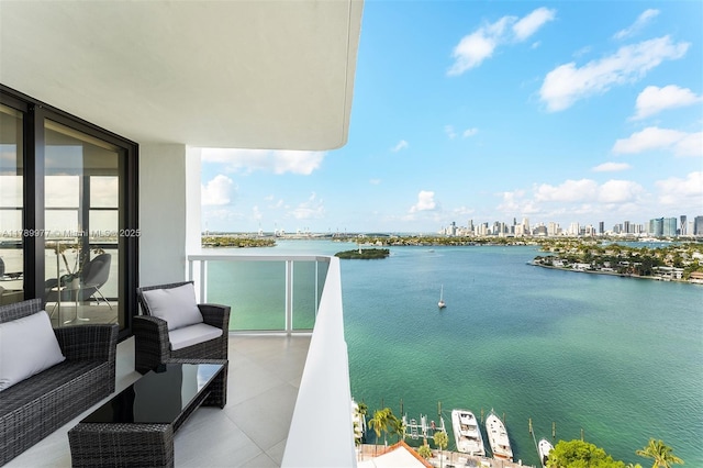 balcony featuring a water view and a view of skyline