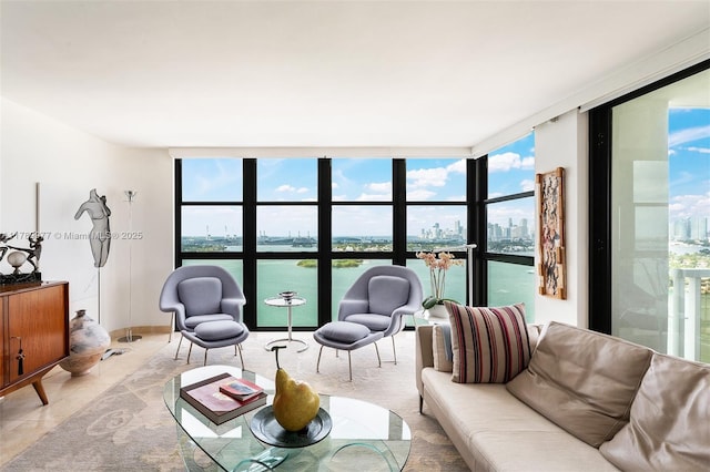 living area with expansive windows, healthy amount of natural light, a view of city, a water view, and light tile patterned flooring