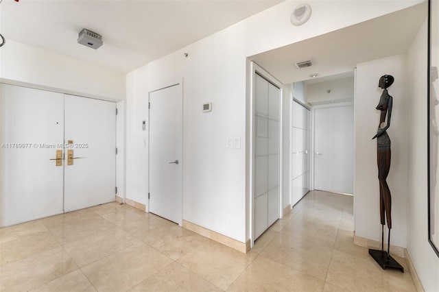 corridor with light tile patterned floors