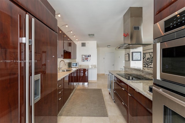 kitchen with high end refrigerator, black electric stovetop, modern cabinets, exhaust hood, and oven
