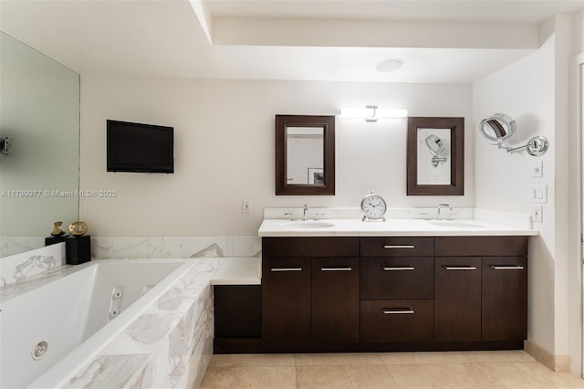 bathroom with a whirlpool tub, double vanity, and tile patterned flooring